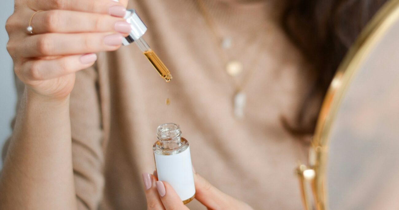 a woman holding a bottle of medicine and a magnifying glass