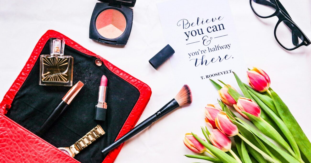 assorted cosmetics and pink tulip flowers